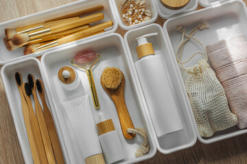 Cosmetics products arranged in white organizers. Creative Drawer Organizing. Storage beauty...