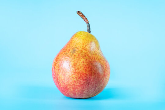 yellow orange pear. forella pear fruits on blue background