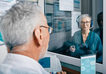 Senior woman receiving hearing exam at audiology clinic. Audiometry, hearing check-up