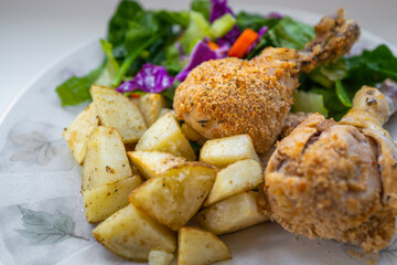 Breaded chicken drumstick roasted homestyle potatoes, green salad