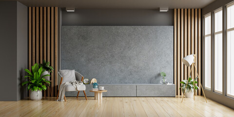Concrete cabinet TV in modern living room with armchair and plant on concrete wall background.