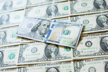 one hundred dollars on a background of one