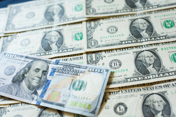 one hundred dollars on a background of one