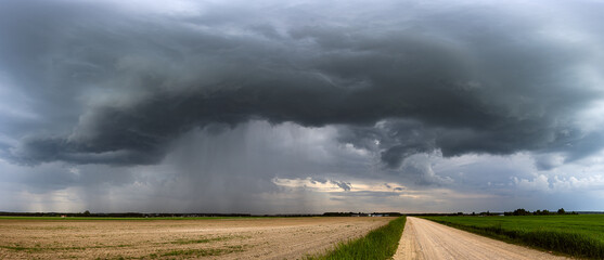 Storm clouds over field, extreme weather, dangerous storm