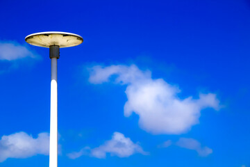 White lamppost in the morning under blue sky