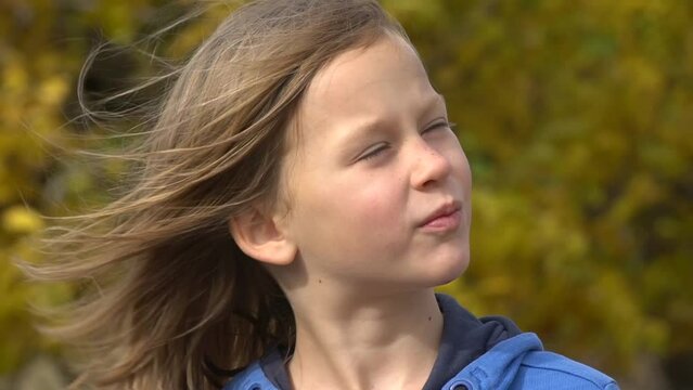 Closeup portrait of happy adorable child girl smiling. Slow motion