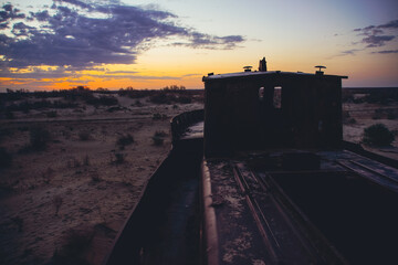 Cemetery of old ships on the former bank of Aral sea during sunrise, Muynak, Uzbekistan