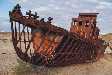 Cemetery of old ships on the former bank of Aral sea during sunrise, Muynak, Uzbekistan