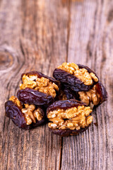 Walnut-stuffed dates on a wood floor. Close-up. Arabian luxury for special occasions such as Ramadan and Eid holidays. local name cevizli hurma