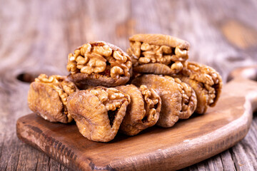 Stuffed dried figs. Dried figs stuffed with walnuts on a wood floor. Close-up. local name cevizli incir