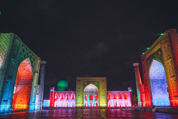 Registan square in Samarkand lit in colourful lights, Uzbekistan
