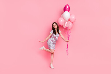 Photo of funky charming lady dressed dotted dress holding balloons dancing isolated pink color background