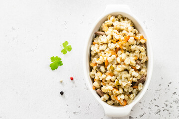 Vegetarian barley with vegetables. Top view, copy space, flat lay.