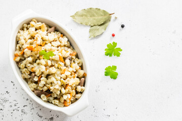 Barley risotto with vegetables and chicken. Top view, copy space, flat lay.