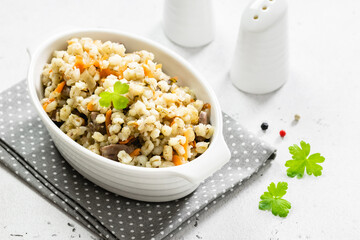 Barley stew with vegetables and chicken. Top view, copy space, flat lay.