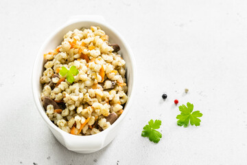 Barley stew with vegetables and chicken. Top view, copy space, flat lay.