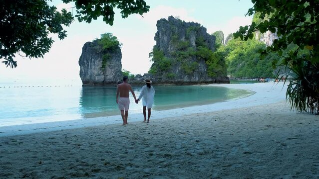 couple men and women on the beach of Koh Hong Island Krabi Thailand, Asian woman and European men on a tropical beach in Thailand. 