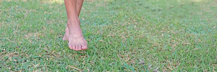stepping barefoot on the green grass
