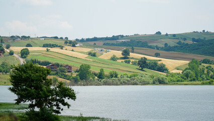 Fototapeta na wymiar landscape with lake, fields, and hills 