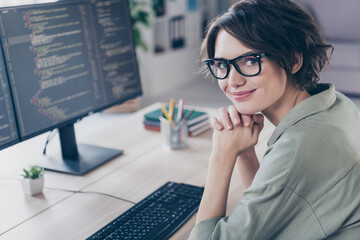 Photo of charming satisfied web designer sitting chair look camera editor create office building