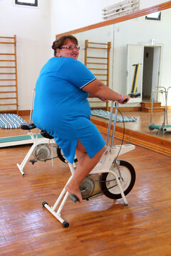 overweight woman exercising on bike
