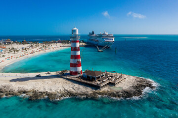 Lighthouse on the island and cruise ship in the blue lagoon, Bahamas Island, View from drone, View...