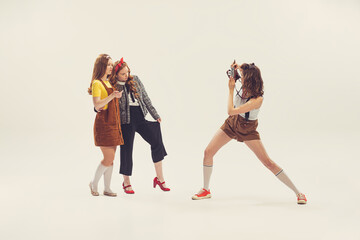 Pretty young women in retro 90s fashion style, outfits isolated over white studio background....