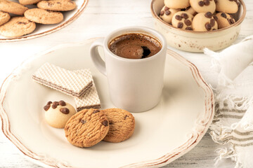 espresso or Turkish coffee with delicious biscuits and cookies on table