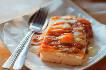 Roti bakar or toast bread is a baked Malaysian sandwich consisting of two slices of bread and stuffing, such as sugar, margarine, butter, egg and jam