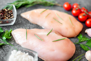 raw chicken breasts on stone background
