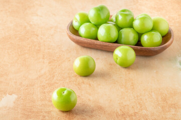 delicious ripe green plum fruits on table