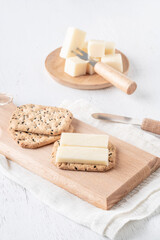 cheese and cracker biscuits on a wooden board