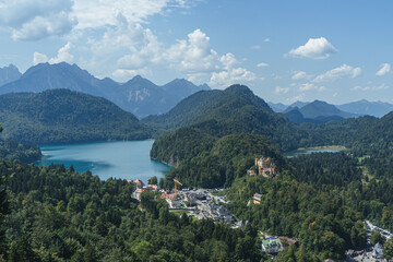 Fototapeta na wymiar Lake in the mountains, Bavaria Alps with castle, Beautiful view in Alps in summer, neuschwanstein castle view, View from above to the castle, View in Bavaria Alps from the top, Mountains and lake