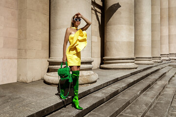 Spring, summer fashion. High fashion model. Glamour, stylish elegant woman. female model in colorful dress in the city. Travel model. Outdoor shoot. Casual, urban style. Vogue.