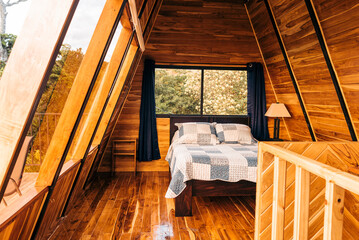 Image of the interior of a beautiful log cabin bedroom with a cozy bed. 