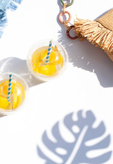 Summer beach drinks, cocktails or lemonade on the white background. Top view.