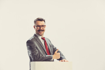 Portrait of smiling businessman wearing grey striped suit in 50s, 60s fashion style isolated on...
