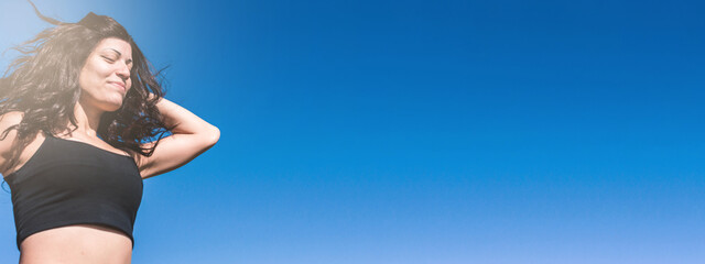 banner, close up latin woman outdoors jogging with eyes closed, copy space.
