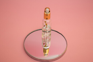 Hand and body care oil on a pink background, subject