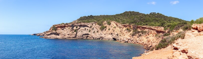 Panoramic view of part of rocky steep coast in the southeast of Ibiza island and clear sea, Balearic Islands, Spain