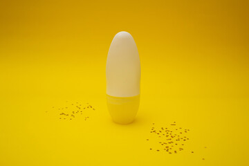 Fototapeta premium Deodorant stands on a yellow background