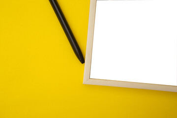 White photo frame on yellow background