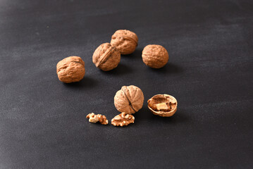 Walnut and walnut shell on dark background.