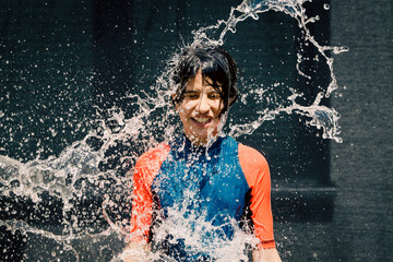 Fototapeta premium Happy girl washing her body with water