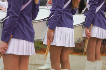 Girls in white skirts with drums