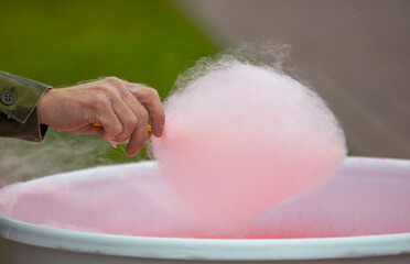 Cooking red cotton candy in park