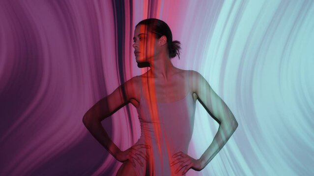 Cute girl in flesh color bodysuit moves standing seductively looks at camera overlay colorful neon lines stripes twisted background. Slim woman posing on hypnotic backdrop illuminated with projector