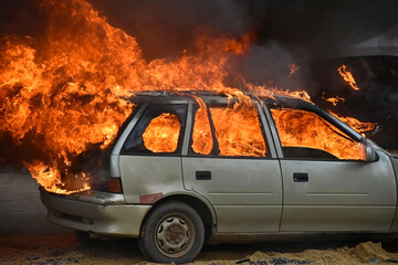 Obraz na płótnie Canvas Burning and flaming car outdoor