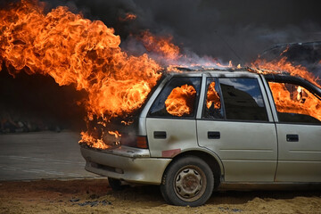 Burning and flaming car outdoor © majorosl66