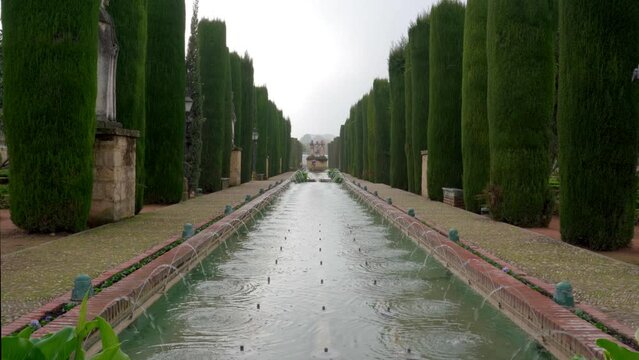 Pan up on Castle of the Christian Monarchs Garden Fountain on Cloudy Day